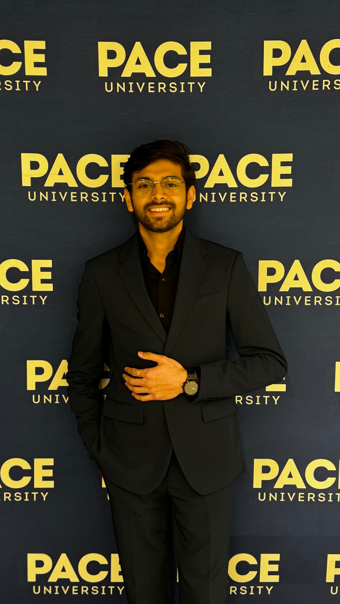 Om Gaikhe in front of the Pace University backdrop