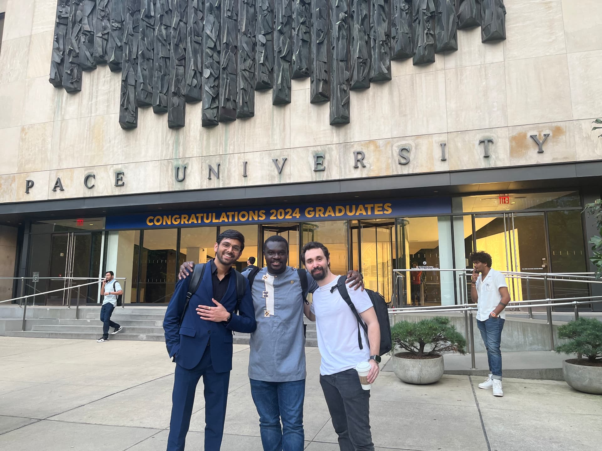 Om Gaikhe with friends outside Pace University on graduation day