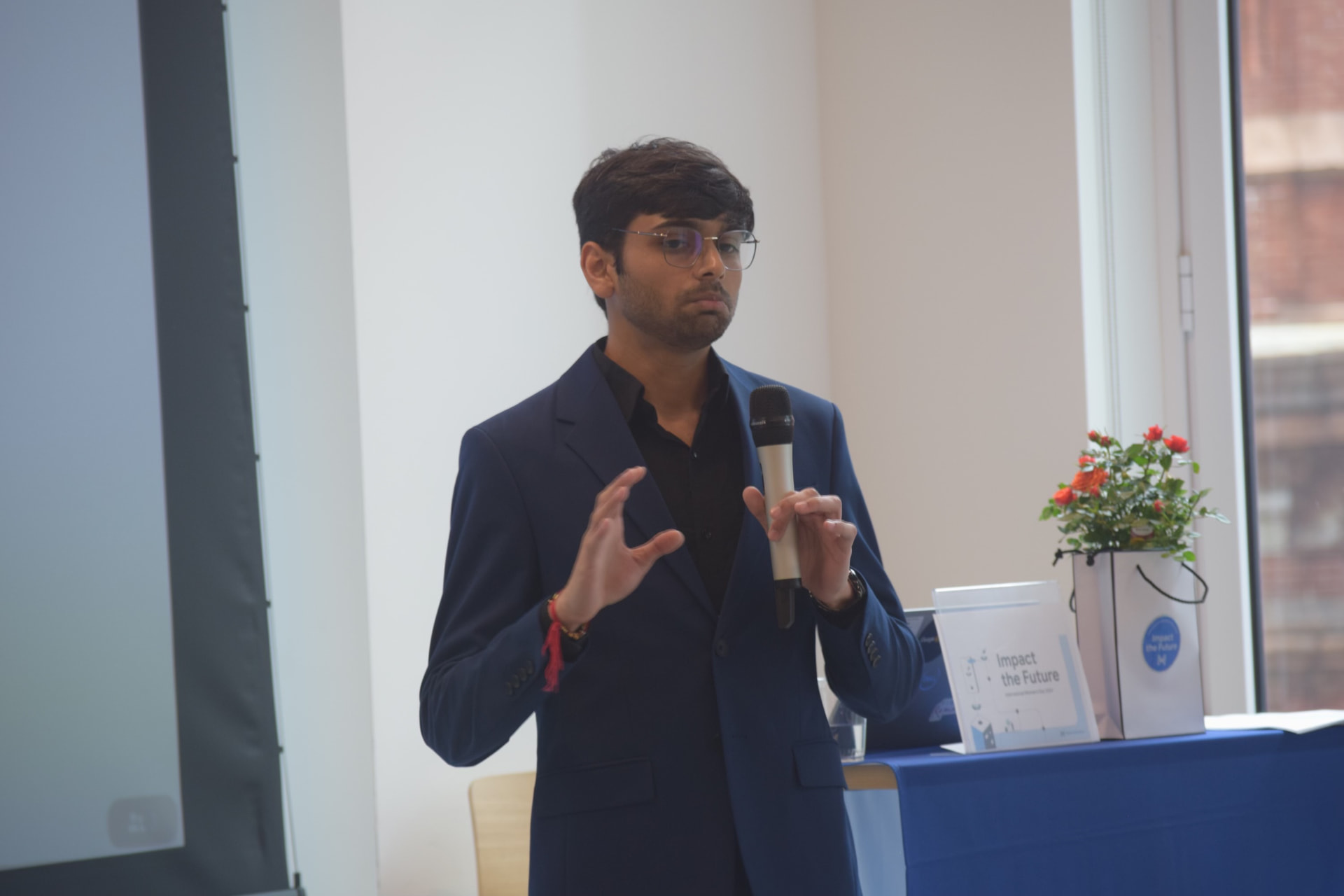 Om Gaikhe presenting with a microphone